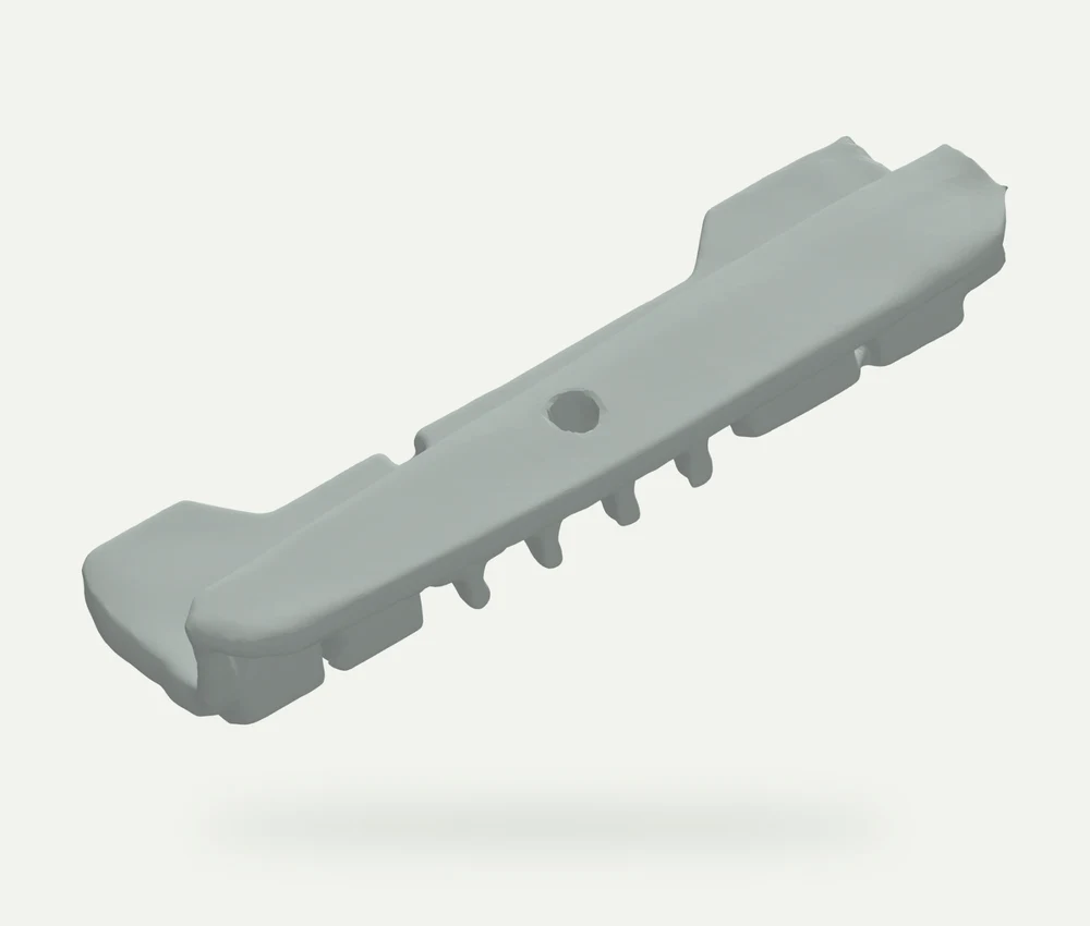 Light grey model render of a long shaped Volvo roof rack pad with curved contact surfaces and locating features