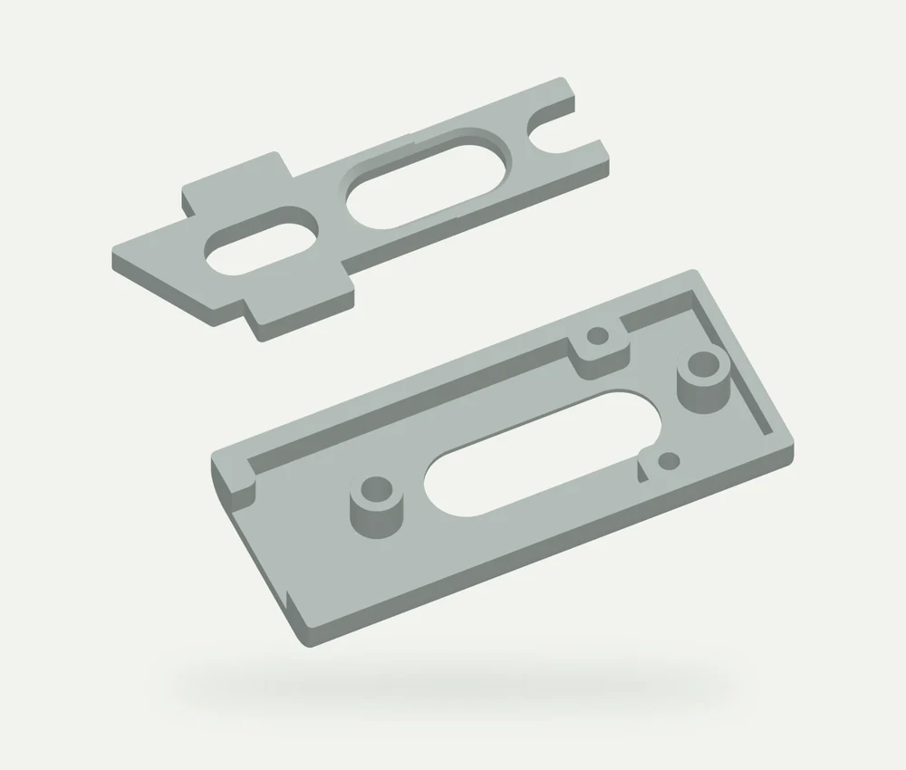 Light grey model render of the two window slider components, a thin slotted slider and a deeper housing, shown separately